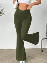 Olive green high waisted flare pants with a ruched waistband designed for stylish and comfortable wear