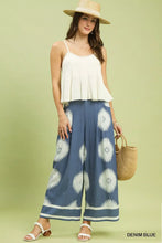 Denim blue umgee abstract border print wide leg pants with white sunburst patterns and matching striped hem