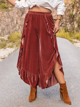 Plus size velvet ruffle hem wide leg pants in rust with a high-waisted elastic waistband and ruffled side slits