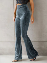High-waisted ribbed velvet flare pants in textured teal velvet with vertical ribbing for a luxurious velvet look