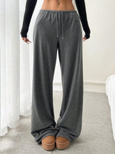 Gray relaxed fit drawstring pants made of soft fabric with a loose fit and subtle brand logo on the side