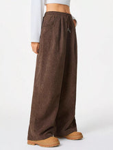Brown corduroy wide leg pants with a drawstring waistband designed for comfortable casual wear