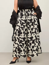 Plus size black and white abstract print wide-leg pants with elastic waistband and geometric pattern