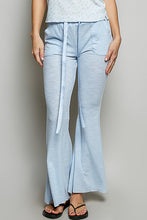 Light blue flare pants made of breathable textured ribbed knit fabric with drawstring waist and side pockets