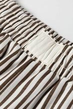 Brown and white striped elastic high waist loose pants with soft gathered fabric and pockets for comfortable wear