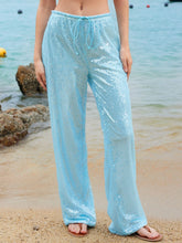 Light blue sequin wide leg pants with drawstring waist featuring shimmer for elegant and comfortable wear