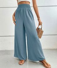 Light blue high-waisted wide leg pants with gathered elastic waistband for comfortable stylish wear