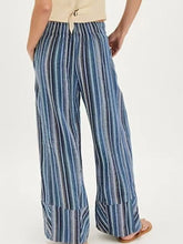 Blue and white vertically striped wide leg pants with a relaxed flowing silhouette for comfortable wear