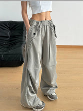 Gray wide leg drawstring pants with relaxed fit and multiple cargo pockets for comfortable casual wear