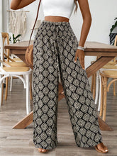 Black and white geometric patterned printed wide leg pants designed for a stylish and comfortable fit