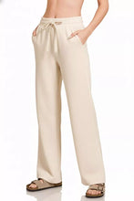 Beige Zenana scuba wide leg pants with drawstring waistband and side pockets in a comfortable wide leg design