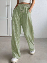 Green and white striped wide leg pants with an elastic waistband for comfortable stylish wear