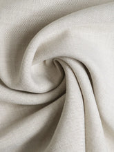 Off-white soft fabric with subtle ribbed texture and gentle folds of slit wide leg pleated pants