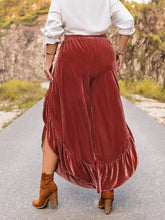 Plus size velvet wide leg pants in rust with high waisted elastic waistband and layered ruffle hem detail
