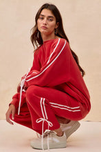 Red oversized sweatshirt with white striped detailing and matching drawstring ties featuring bow details fleece design