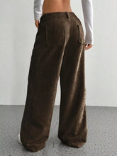 Brown corduroy wide leg pants with relaxed fit and back pockets showing corduroy texture ideal for ankle boots