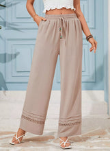 Beige casual wide-leg pants with drawstring waist and delicate lace trim on cuffs for comfortable wear