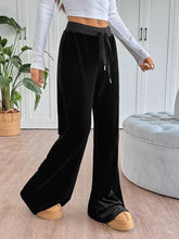 Black velvet wide-leg drawstring pants featuring a comfortable waistband ideal for casual wear and easy care instructions