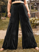 Plus size velvet ruffle hem wide leg pants in black velvet with tiered ruffles and high-waisted design