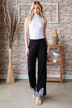 Heimish black solid damask casual pants with wide-leg design and white floral embroidery at the cuffs plus size