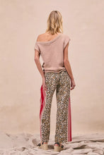 Beige leopard print pants with bold red and white vertical side stripes from bi bi featuring welt pockets