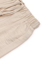 Beige linen drawstring wide leg pants with a comfortable waistband suitable for machine wash cold care