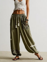 Olive green lace detail drawstring harem pants with wide-leg fit and lace pockets and hem for comfortable wear