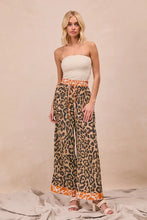 BiBi leopard print wide-leg pants feature an orange and beige elastic waistband for stylish comfort