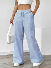 Light blue and white striped wide leg pants with a drawstring waistband in a comfortable wide leg design