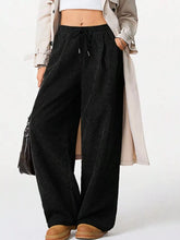 Black wide leg corduroy drawstring pants with elastic waistband for comfortable casual wear