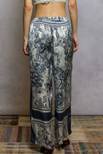 Wide leg floral printed woven pants in navy and cream toile fabric with striped waistband and hem accents