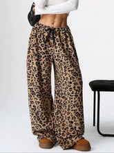 Cropped leopard wide leg plush pants in soft fabric with black drawstring waistband and leopard print pattern