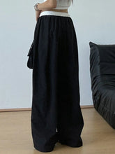 Black wide leg drawstring casual pants with white elastic waistband and side pocket for comfortable wear