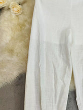 White linen elastic waist pants with subtle textured weave designed for comfort and machine wash cold care