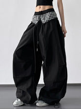 Black wide leg pants featuring a checkered pattern waistband and drawstring detailing for casual wear