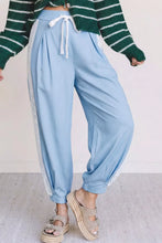 Light blue wide leg jogger pants with lace accent floral patched pockets and pleated slouchy design