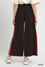 Brown umgee wide leg pants featuring red side stripes and subtle patterned trim for stylish comfort