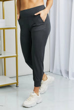 Black high-waisted cropped joggers from leggings depot with wide waistband side pockets and tapered leg design