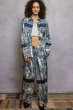 Blue and white patterned silk pajama set with striped collar and cuffs paired with printed woven wide leg floral pants