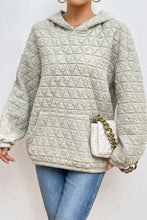 Light gray quilted long sleeve hoodie with hood and front pocket