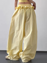 Yellow ruffled drawstring wide leg pants made of lightweight fabric perfect for comfortable summer wear