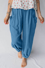 Blue loose-fitting smocked waist casual jogger pants with side pockets and gathered cuffs for comfort and style