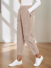 Beige corduroy elastic waist cropped pants with tapered relaxed fit and button detailing on side seam