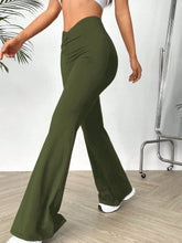 Olive green high waisted flare pants made of smooth stretchy fabric with subtle side seam detailing