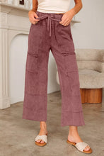 Mauve corduroy wash wide leg pants with drawstring waist and patch pockets featuring wide leg design and care instructions