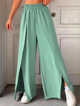 Mint green slit wide leg pants with drawstring waist and side slits in lightweight fabric for casual wear