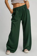Dark green umgee wide leg pants with elastic waistband and drawstring in soft sweatpants material