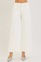 White wide-leg denim trousers featuring a clean minimalist design in risen high rise ankle wide pants style
