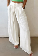 White flowy wide leg pants with drawstring waist and relaxed fit for comfortable casual wear