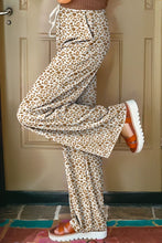 Cream-colored leopard print loose pants with a drawstring waist and relaxed fit for comfortable wear